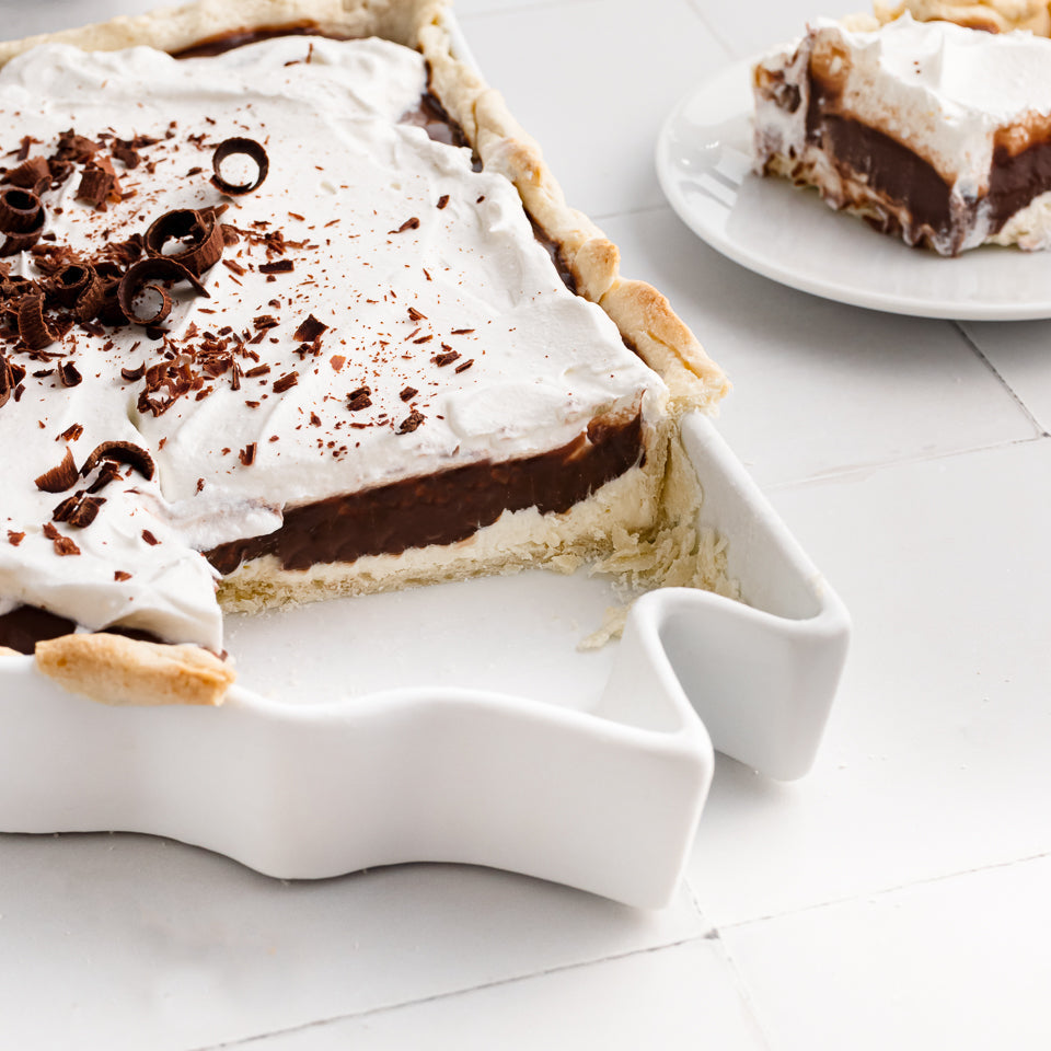 detail shot of chocolate and cream pie in a white pie dish shaped like Arkansas