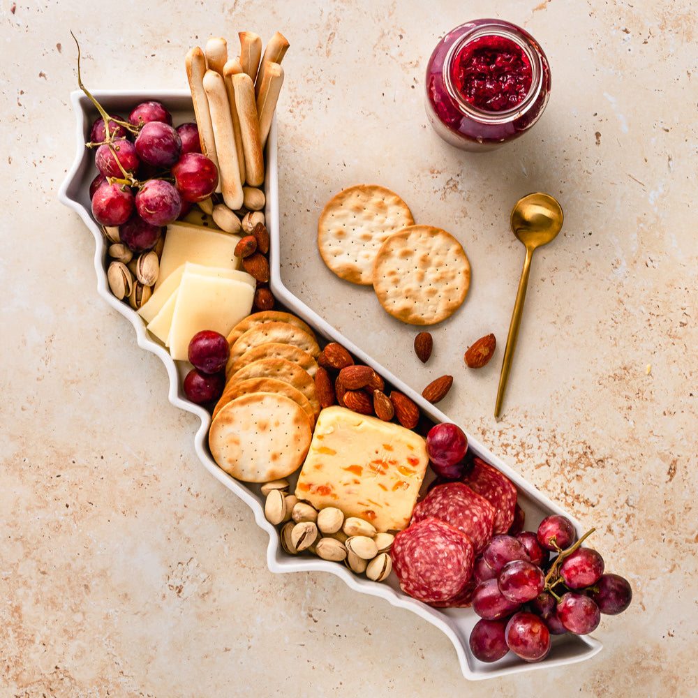 charcuterie board with cheese and cured meats in a california shaped serving tray platter dish