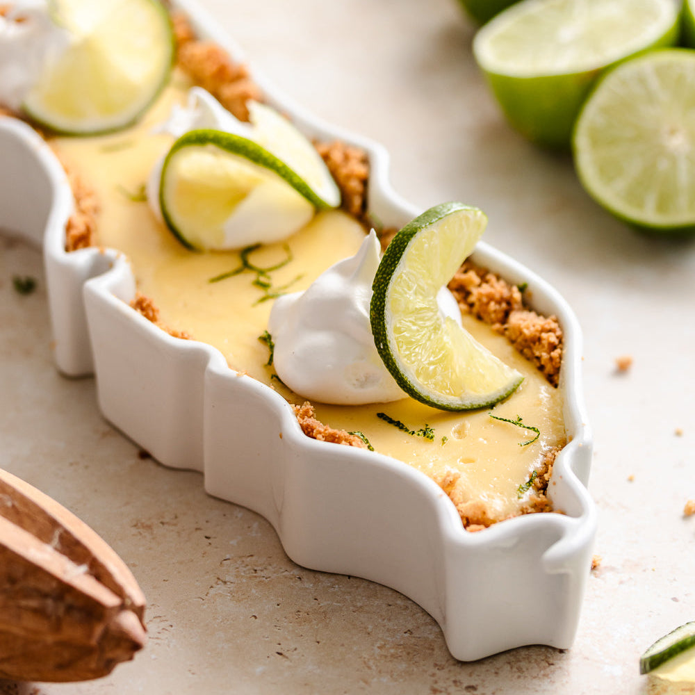 Close of up of wavy, unique silhouette of Florida pie dish. Florida State Plate shown with a dessert, key lime pie. The FL State Plate can be used for food in the oven. Florida dessert dish. Florida pie dish. Florida serving dish. FL ceramic dish. Florida gift. 