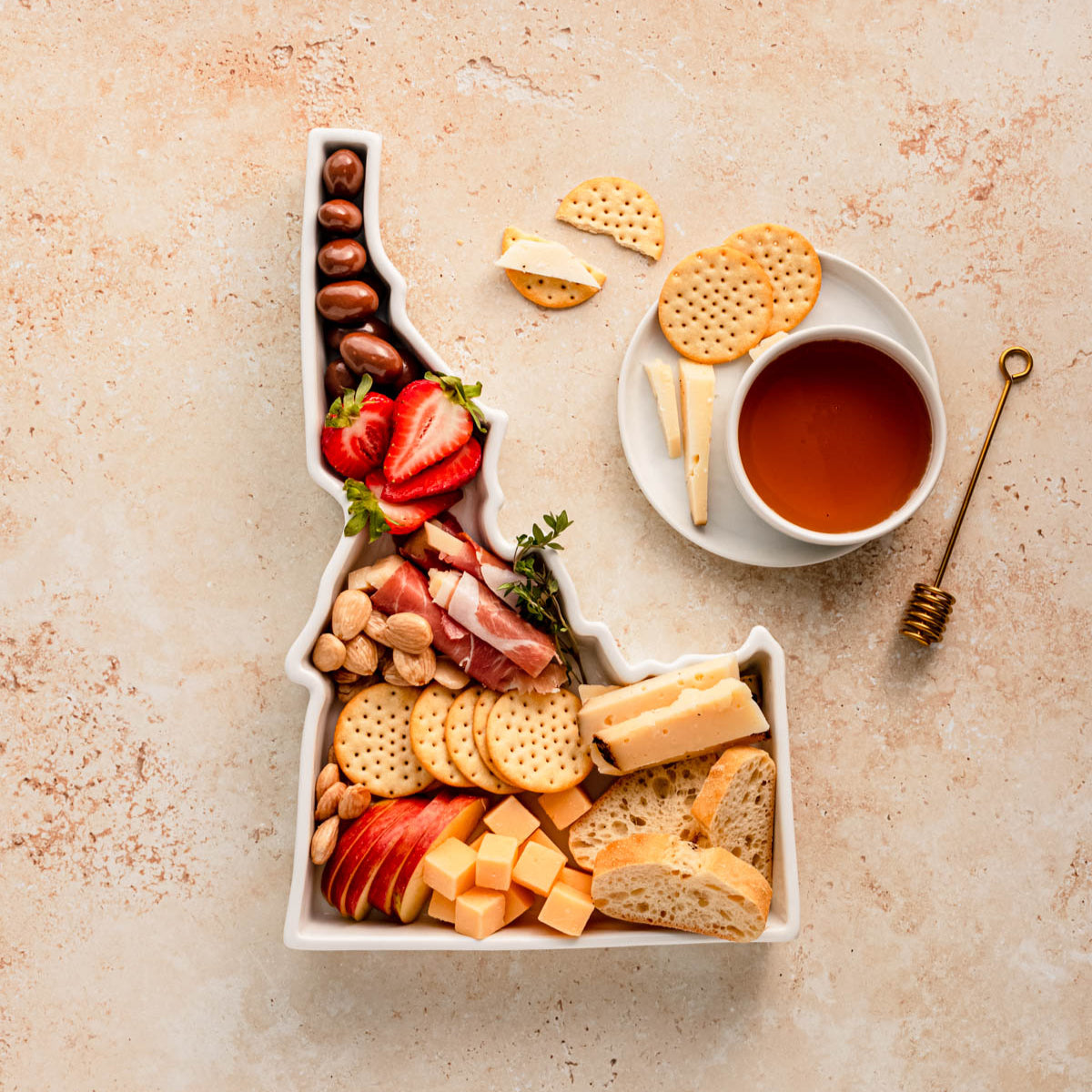 charcuterie board with cheese and cured meats in a Idaho shaped serving tray platter dish