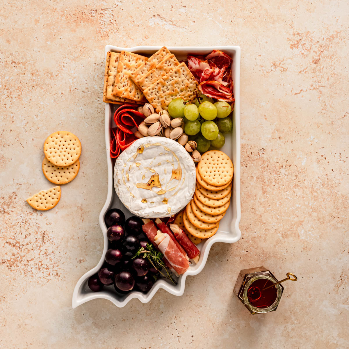 charcuterie board with cheese and cured meats in a Indiana shaped serving tray platter dish