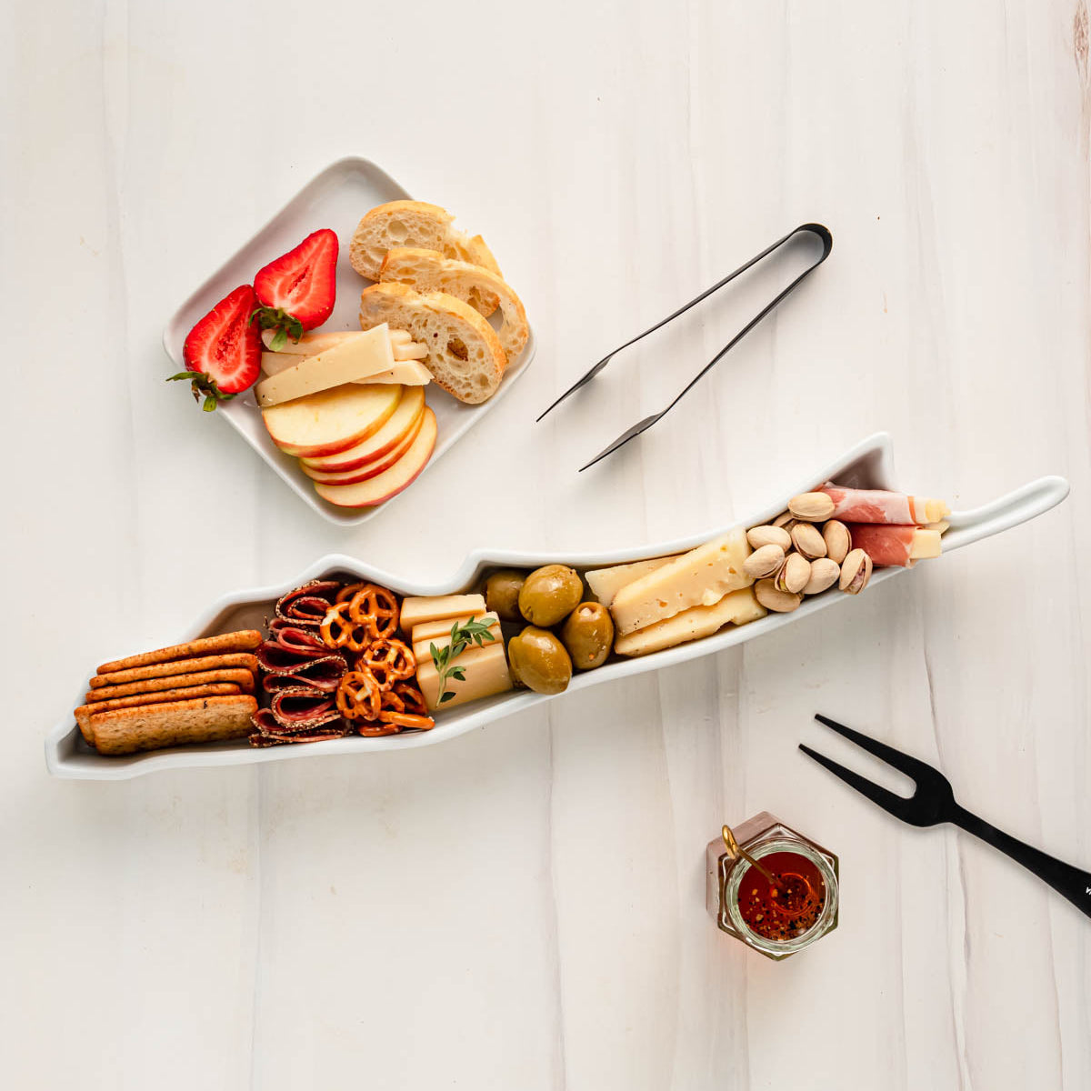 charcuterie board with cheese and cured meats in a Long Island shaped serving tray platter dish