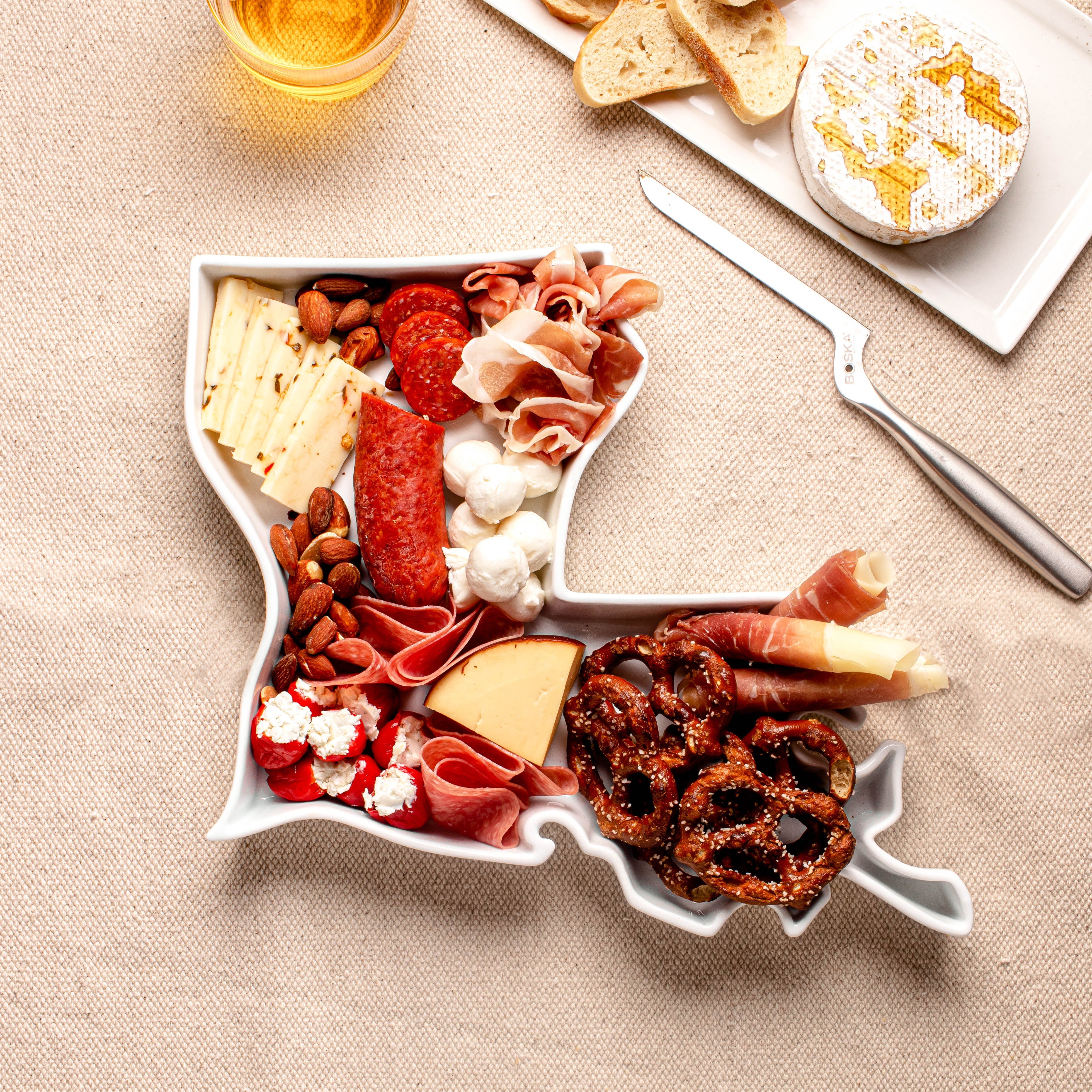 charcuterie board with cheese and cured meats in a Louisiana shaped serving tray platter dish