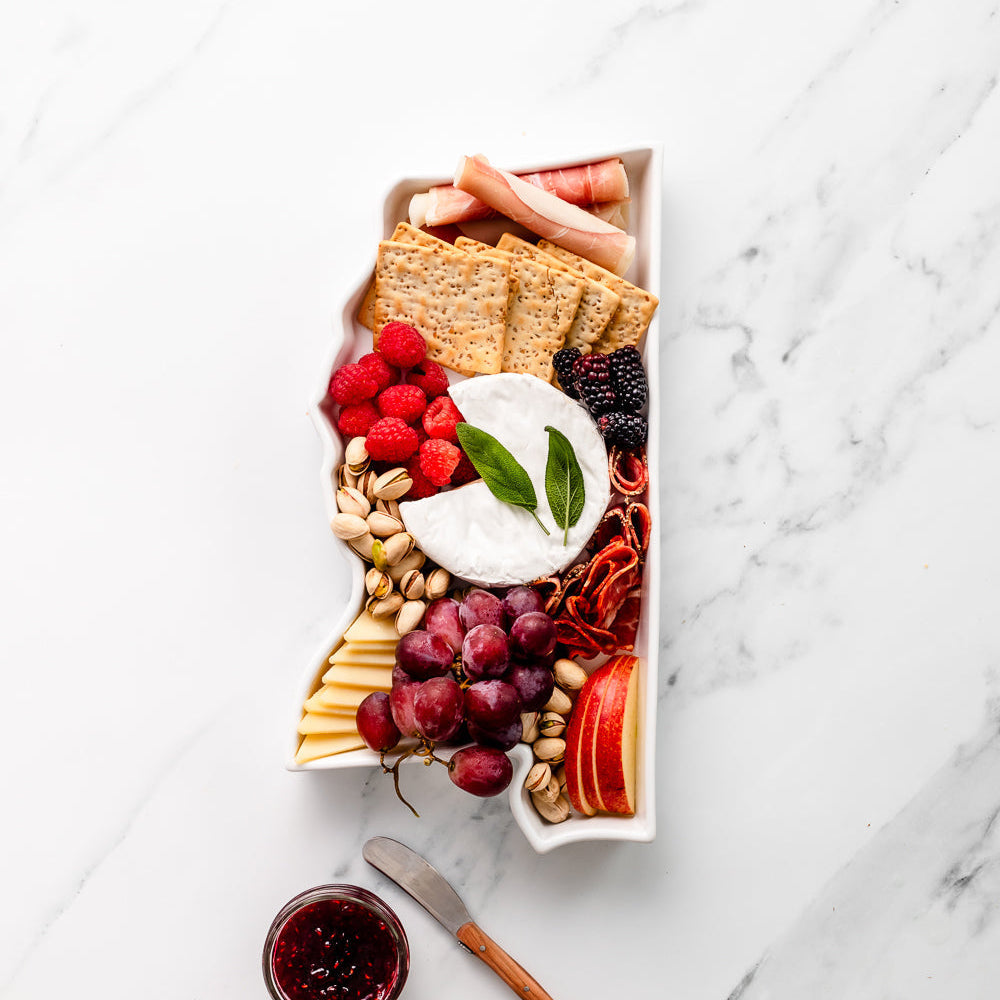 charcuterie board with cheese and cured meats in a Mississippi shaped serving tray platter dish