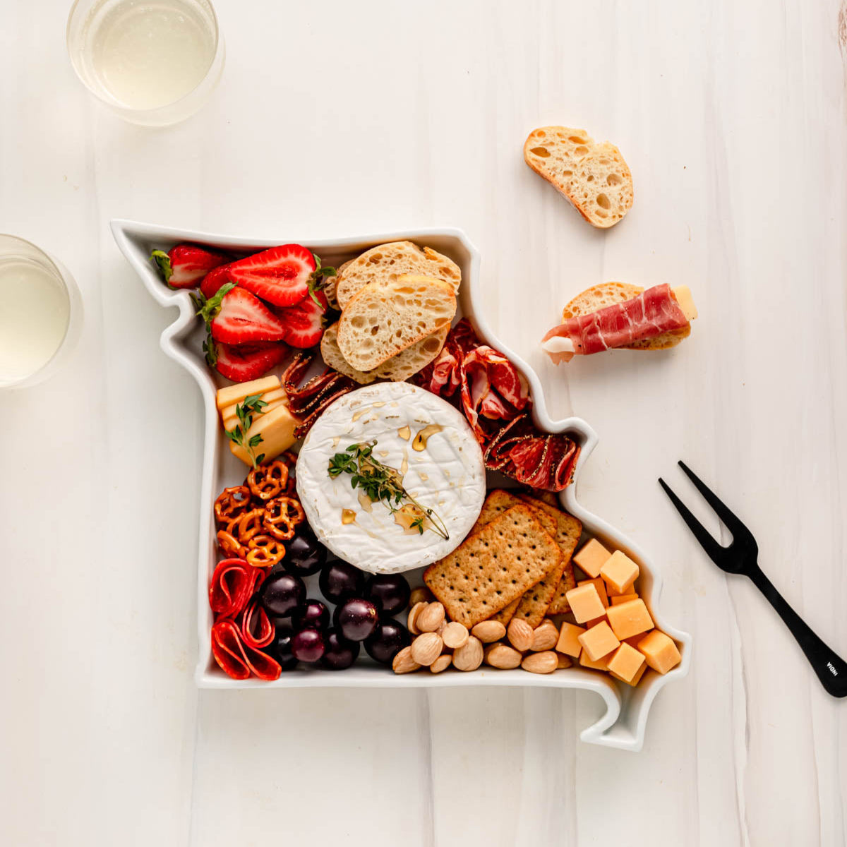 charcuterie board with cheese and cured meats in a Missouri shaped serving tray platter dish
