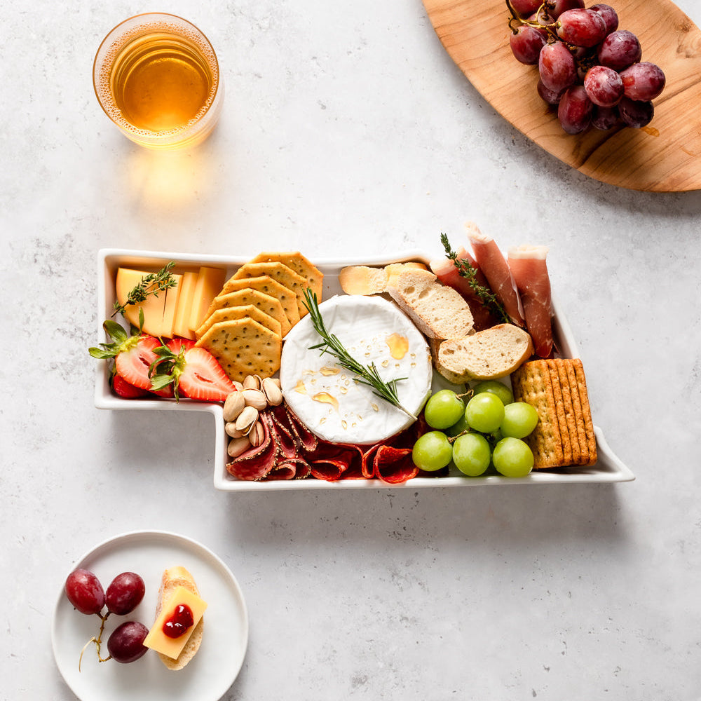 charcuterie board with cheese and cured meats in a Nebraska shaped serving tray platter dish