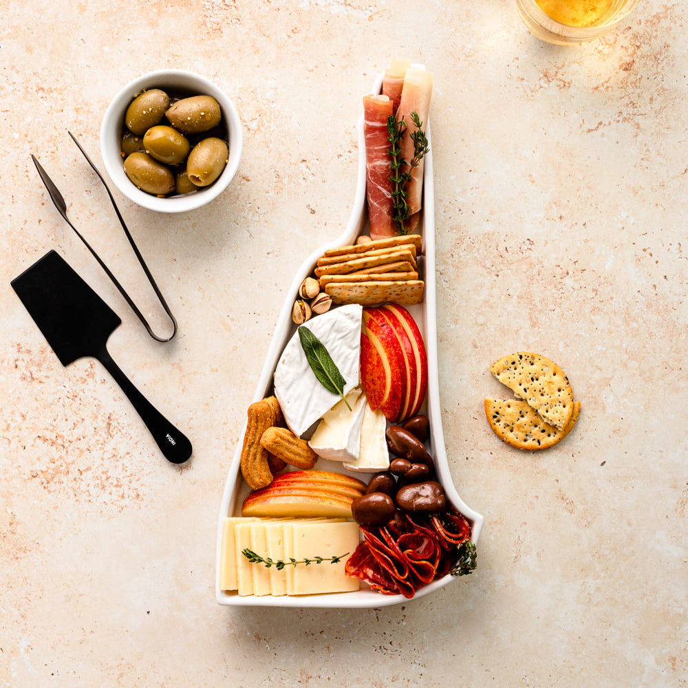 charcuterie board with cheese and cured meats in a New Hampshire shaped serving tray platter dish
