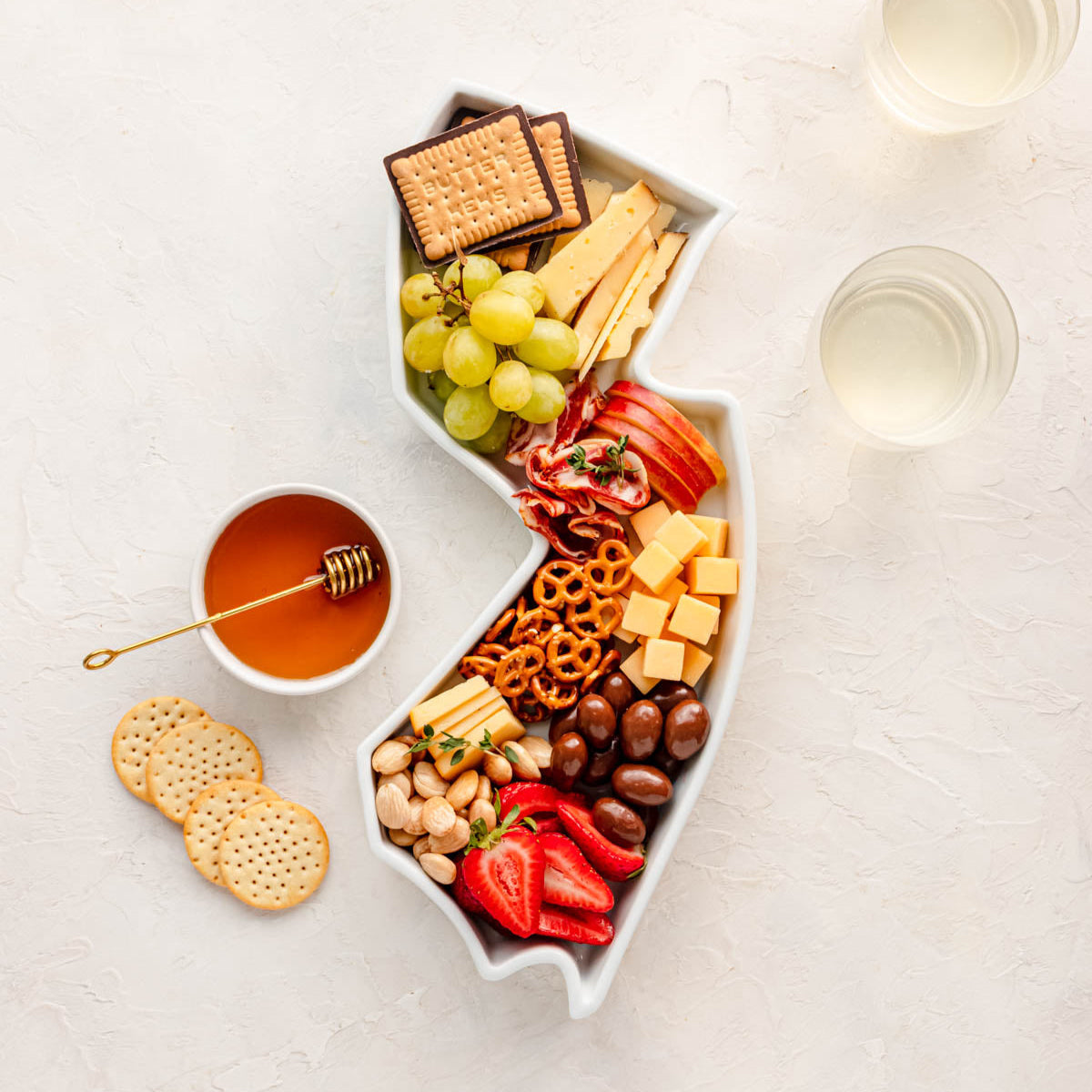 charcuterie board with cheese and cured meats in a New Jersey shaped serving tray platter dish
