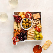 charcuterie board with cheese and cured meats in a New Mexico shaped serving tray platter dish
