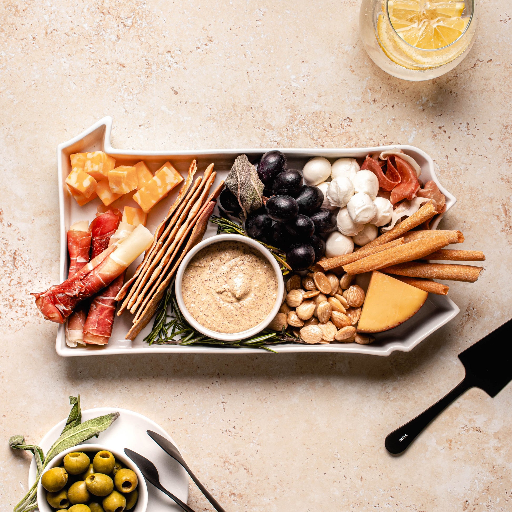 charcuterie board with cheese and cured meats in a Pennsylvania shaped serving tray platter dish