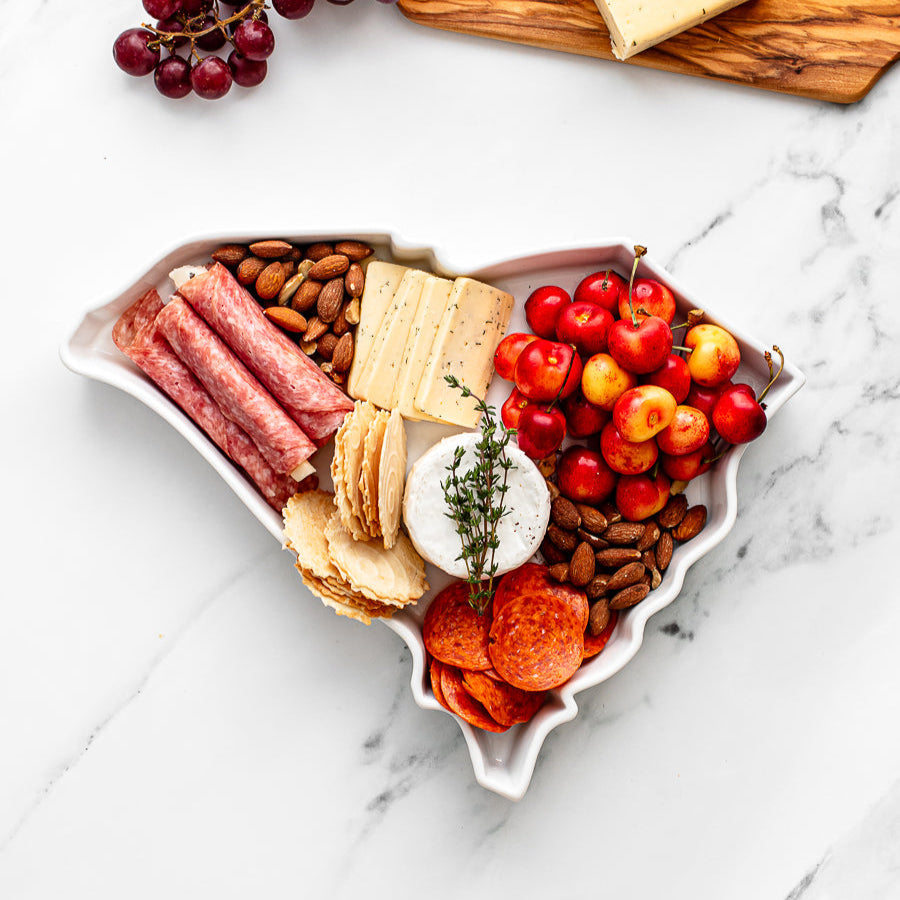 charcuterie board with cheese and cured meats in a South Carolina shaped serving tray platter dish