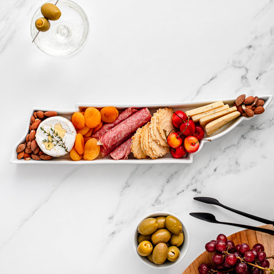charcuterie board with cheese and cured meats in a Tennessee shaped serving tray platter dish
