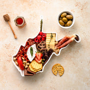 charcuterie board with cheese and cured meats in a West Virginia shaped serving tray platter dish